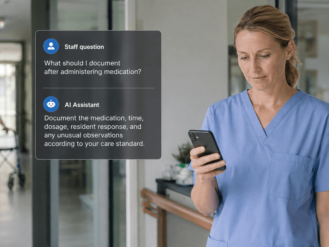 A nurse looks at her phone showing an AI assistant answering a documentation question, an elderly resident walking with a rollator visible in the corridor behind her